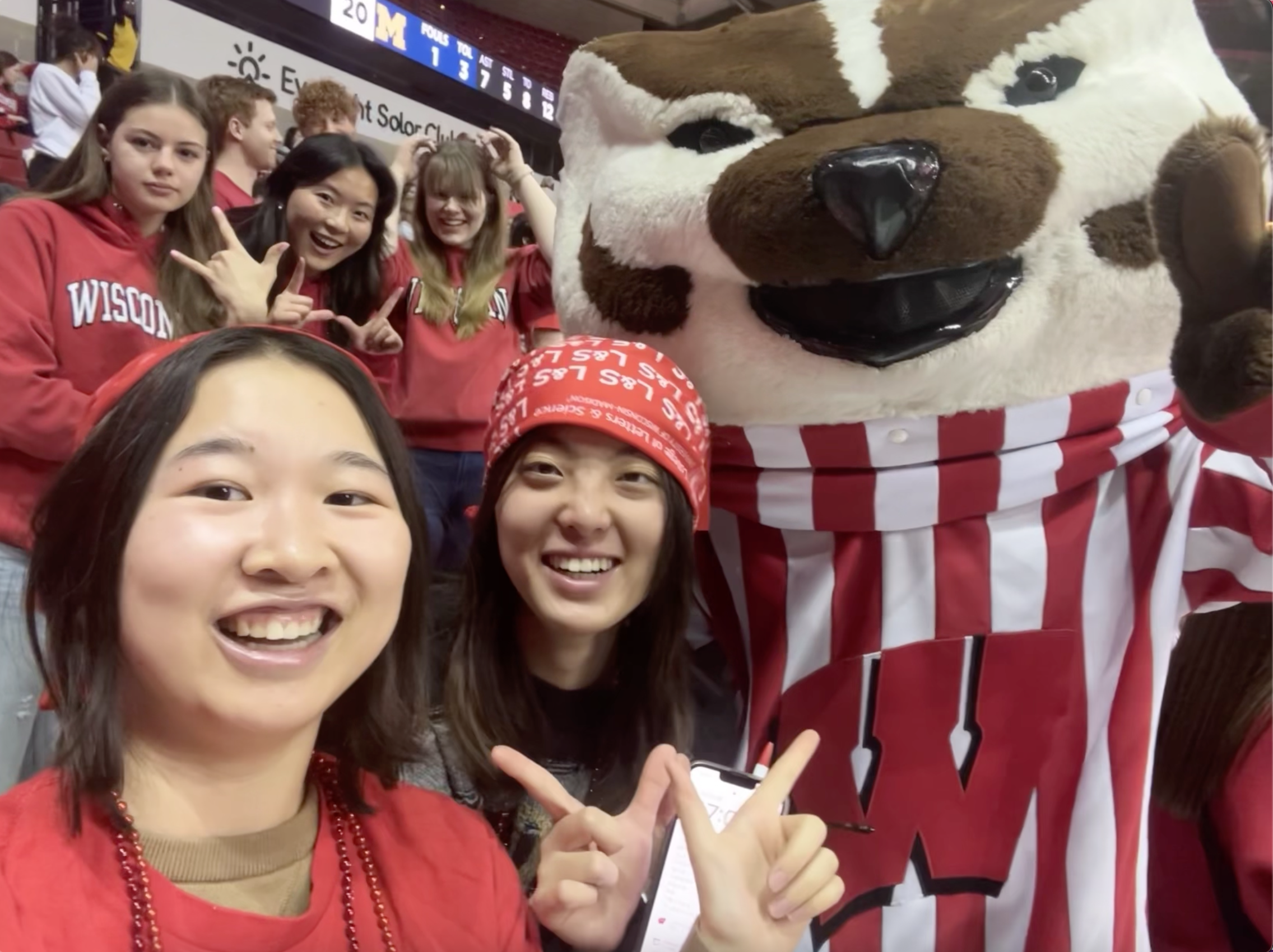Photo with friends and the campus mascot at a school sports event